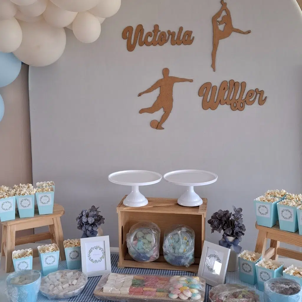 Detalle de mesa dulce gimnasia artística con chuches variadas, bandejas decorativas y detalles temáticos.